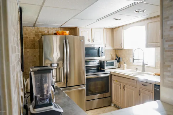 a kitchen with a sink appliances and cabinets