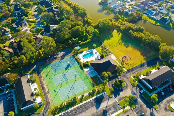 an aerial view of a house yard swimming pool and outdoor seating