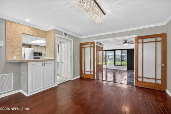 a kitchen with granite countertop a sink a stove and cabinets