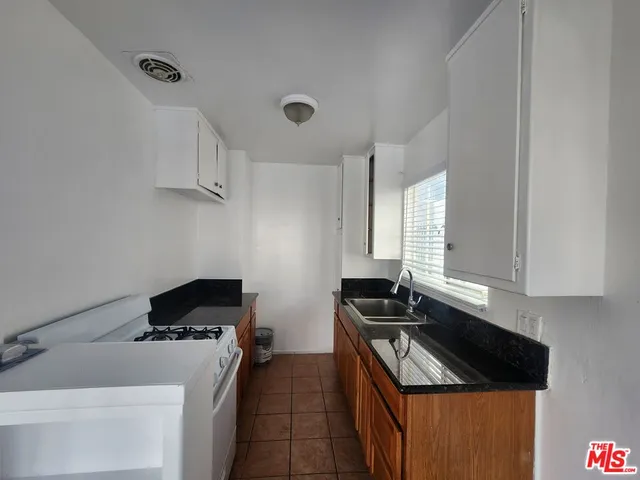 a kitchen with a sink stove and cabinets