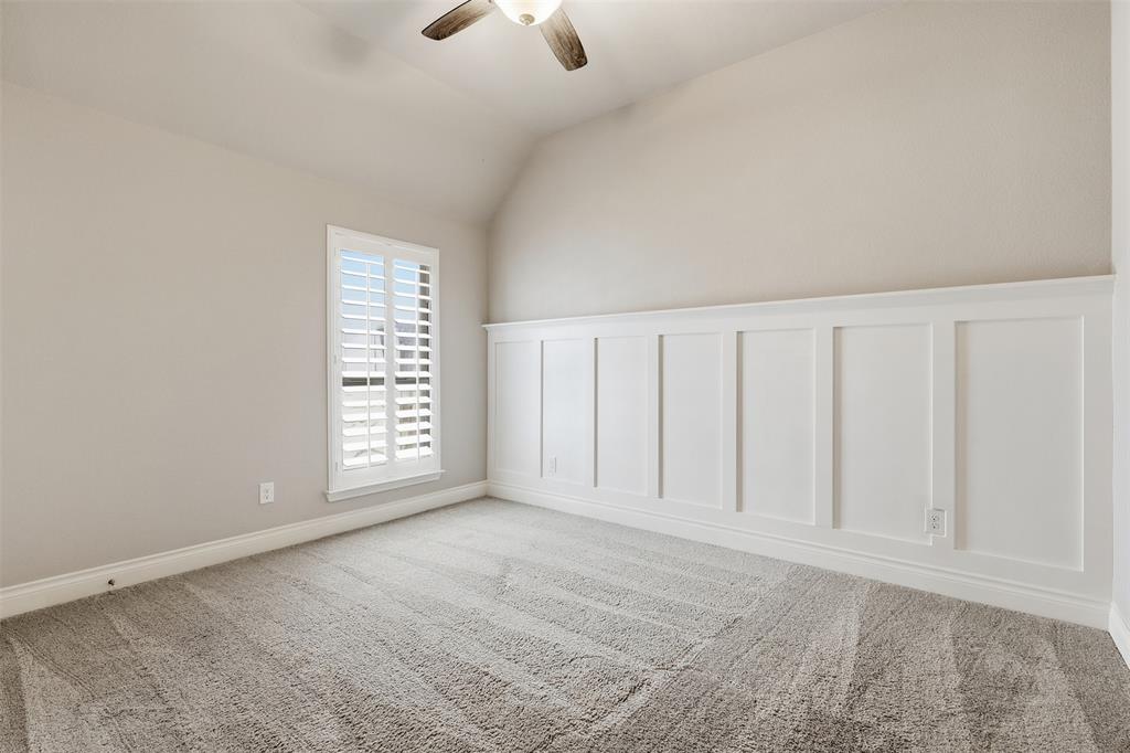 5640 Pradera Road Fort Worth, TX 76126 - Photo 22 of 35 Sloped ceiling, ceiling fan, carpet flooring, window with plantation shutters, and wainscoting detail