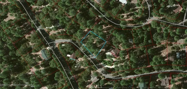 a backyard of a house with table and chairs under an umbrella