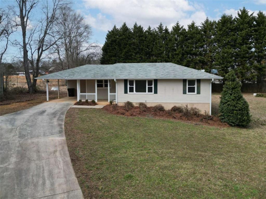 1737 Virgil Moon Road Loganville, GA 30052 - Photo 1 of 1 a front view of a house with a yard