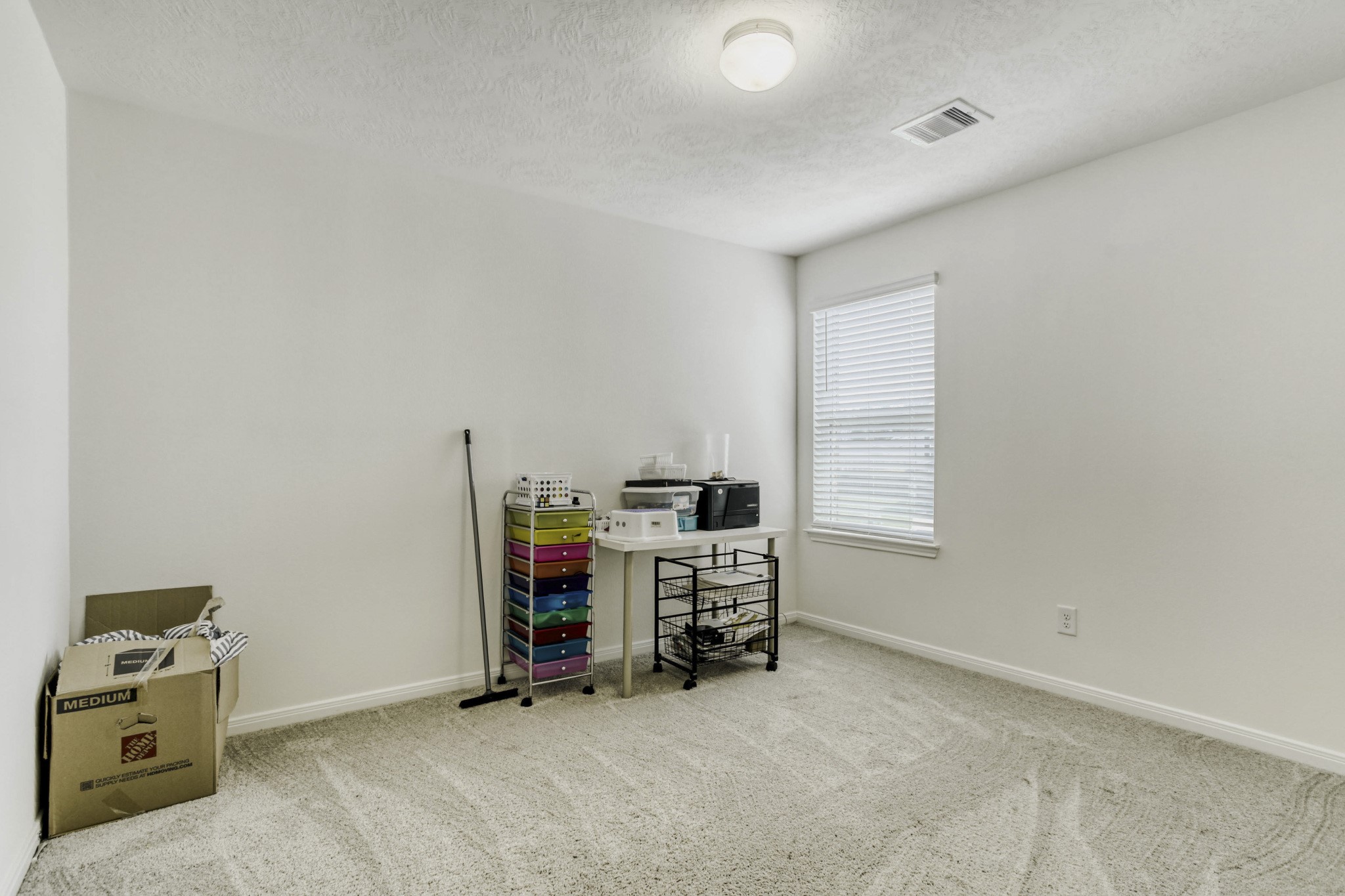 3331 Forest Chitto Dr Spring Spring, TX 77373 - Photo 12 of 29 This room is bright and versatile, featuring neutral walls, a carpeted floor, and a window with blinds. Perfect as an office or additional bedroom.