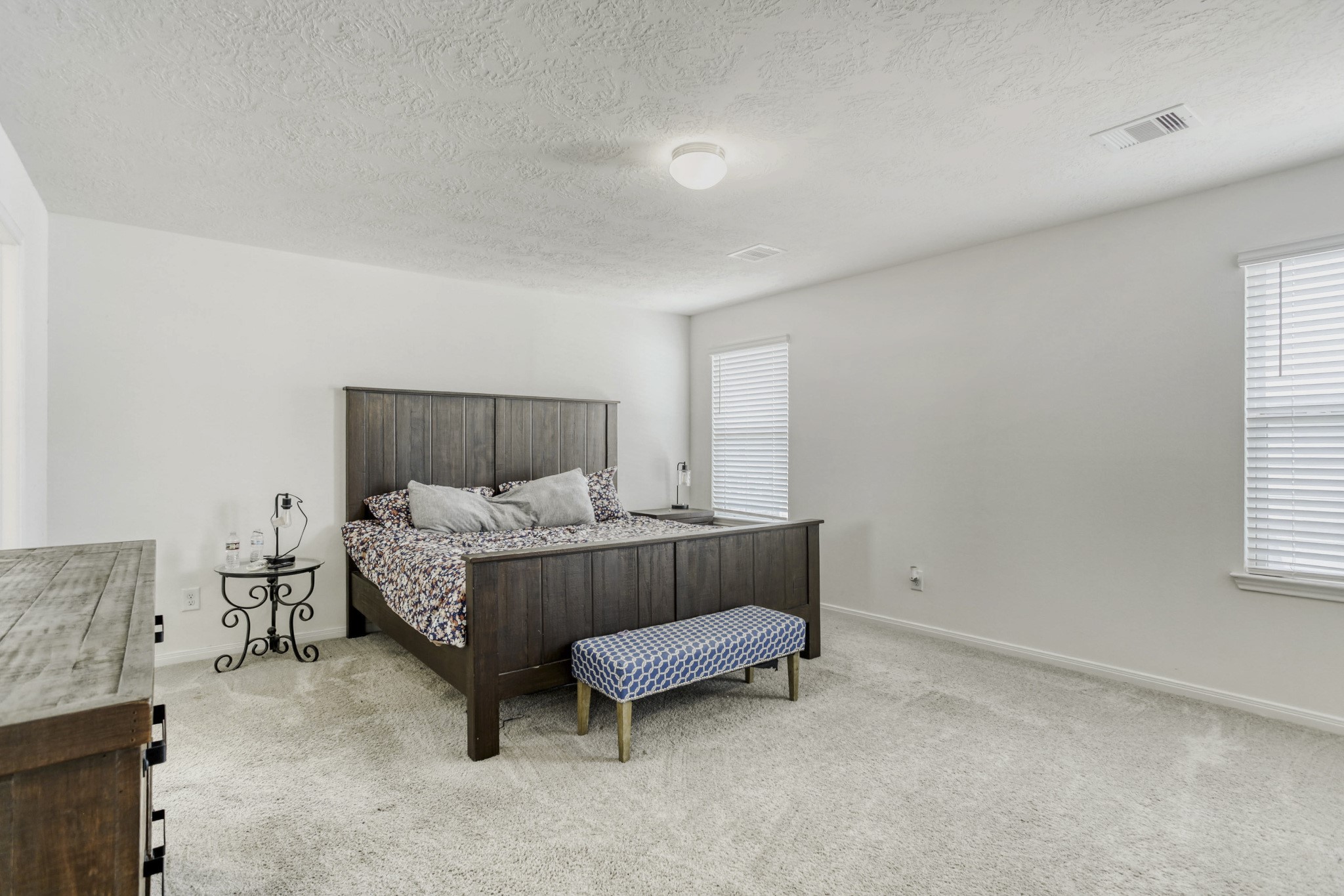 3331 Forest Chitto Dr Spring Spring, TX 77373 - Photo 15 of 29 Spacious and bright primary bedroom with neutral walls and carpeting. Ideal for relaxation and comfort.