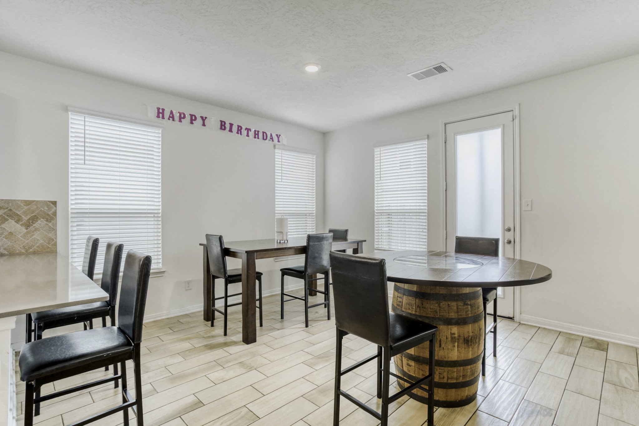 3331 Forest Chitto Dr Spring Spring, TX 77373 - Photo 8 of 29 Bright dining area with modern tile flooring, featuring multiple windows for natural light.