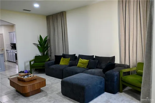 a living room with furniture and a potted plant