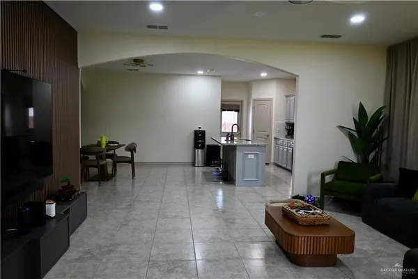 a living room with furniture and a potted plant
