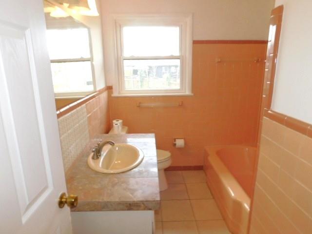 2407 Summerland Drive Decatur, GA 30032 - Photo 14 of 22 a bathroom with a granite countertop sink a toilet and a mirror