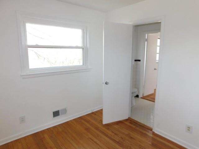 2407 Summerland Drive Decatur, GA 30032 - Photo 22 of 22 an empty room with wooden floor and a window