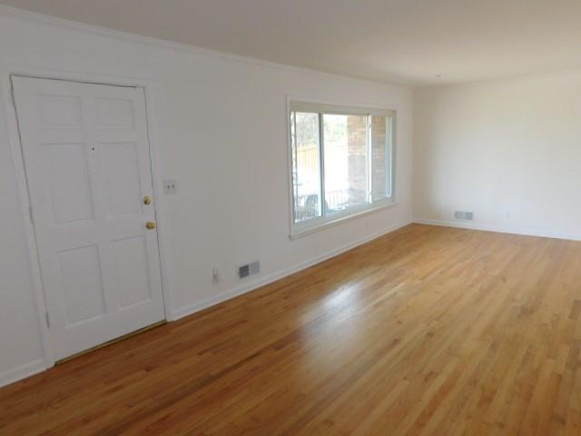 2407 Summerland Drive Decatur, GA 30032 - Photo 3 of 22 an empty room with wooden floor and windows