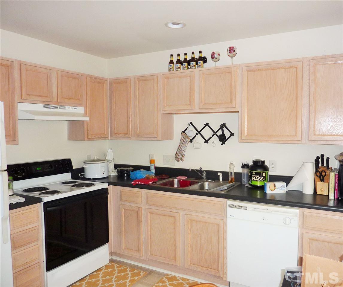 22 Red Lane Raleigh, NC 27606 - Photo 2 of 7 a kitchen with white cabinets and sink