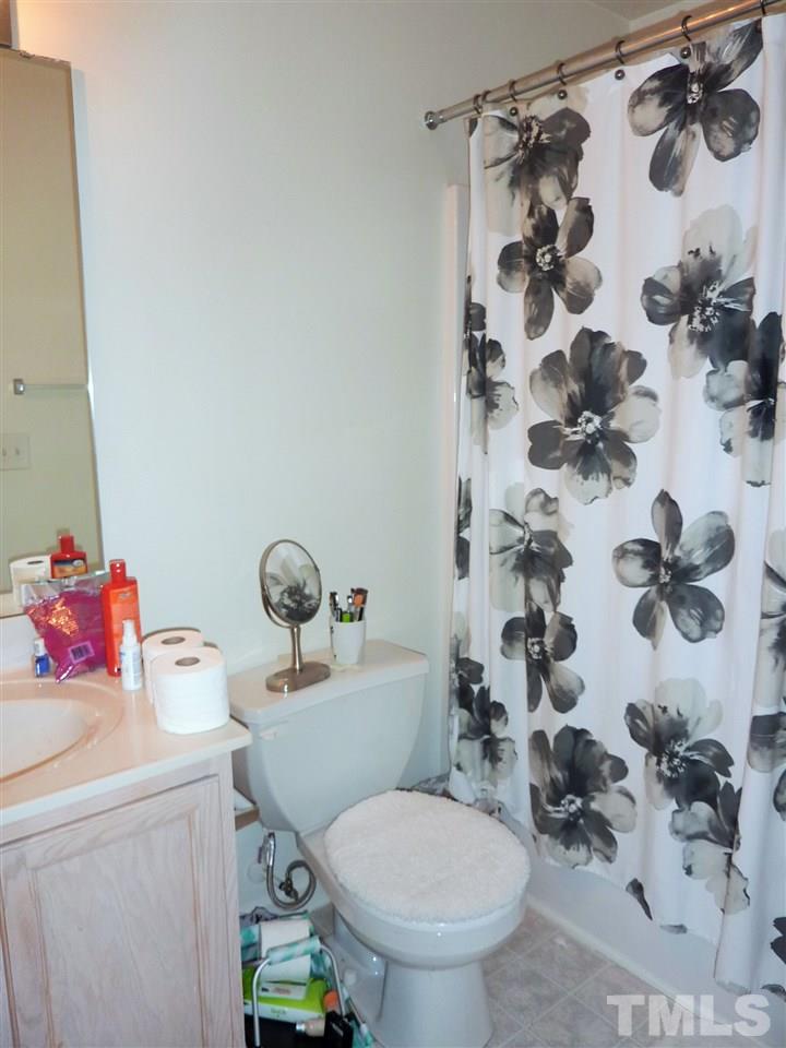 22 Red Lane Raleigh, NC 27606 - Photo 4 of 7 a bathroom with a toilet sink and shower curtain