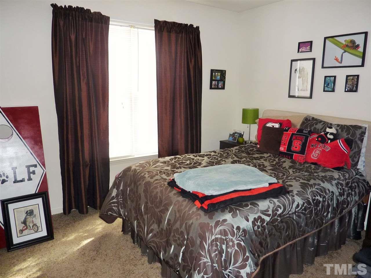 22 Red Lane Raleigh, NC 27606 - Photo 5 of 7 a bedroom with a bed and painting on the wall