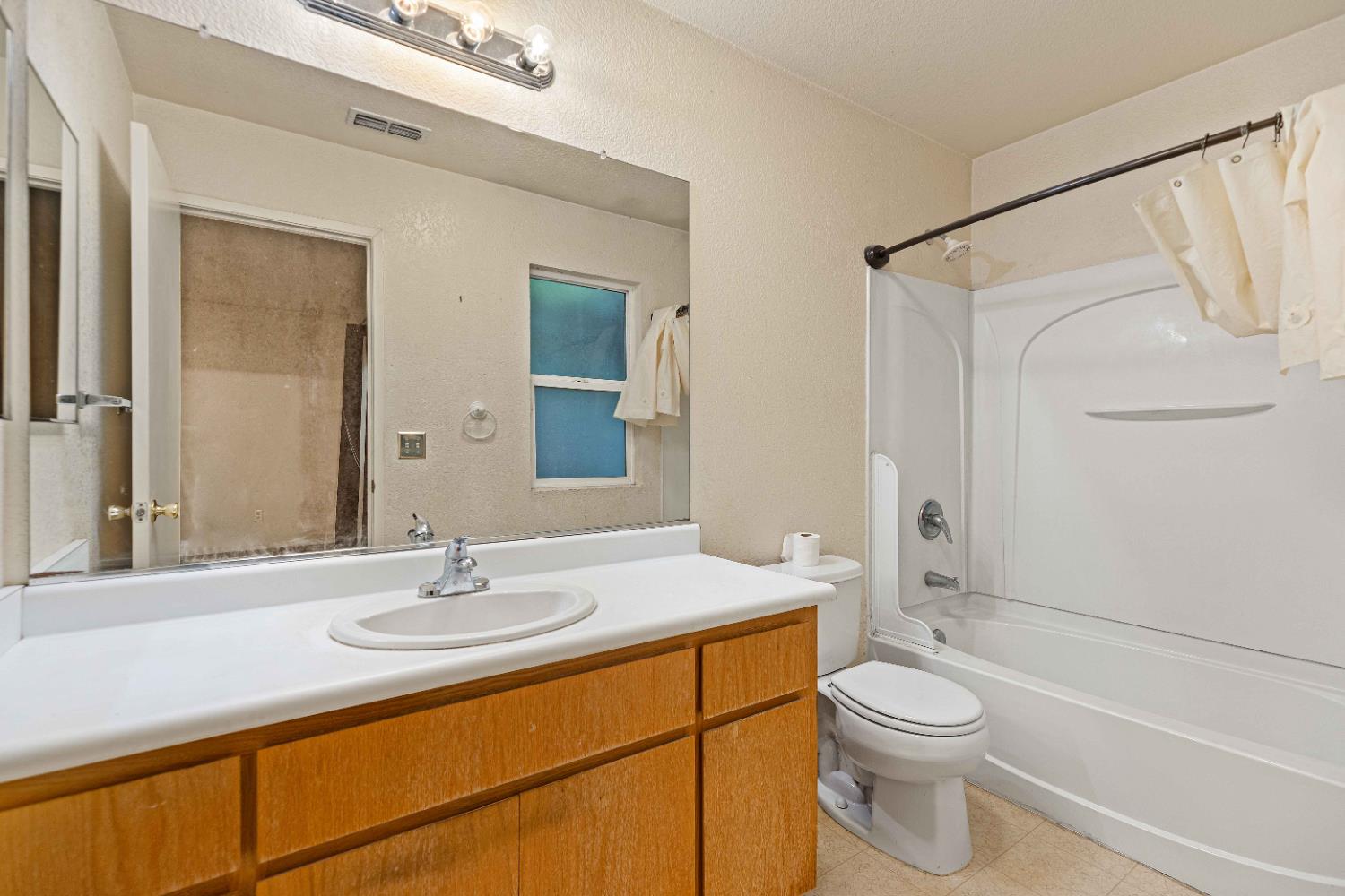 310 West F Street Turlock, CA 95380 - Photo 12 of 27 a bathroom with a sink a toilet and shower