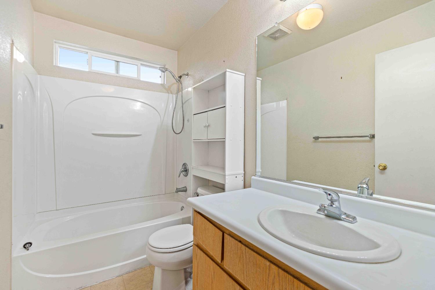 310 West F Street Turlock, CA 95380 - Photo 15 of 27 a bathroom with a sink a toilet and shower
