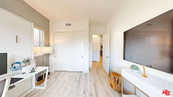 a view of a kitchen with a sink dishwasher stove and wooden floor
