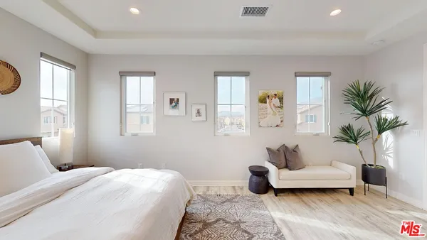 a bedroom with a bed and a couch