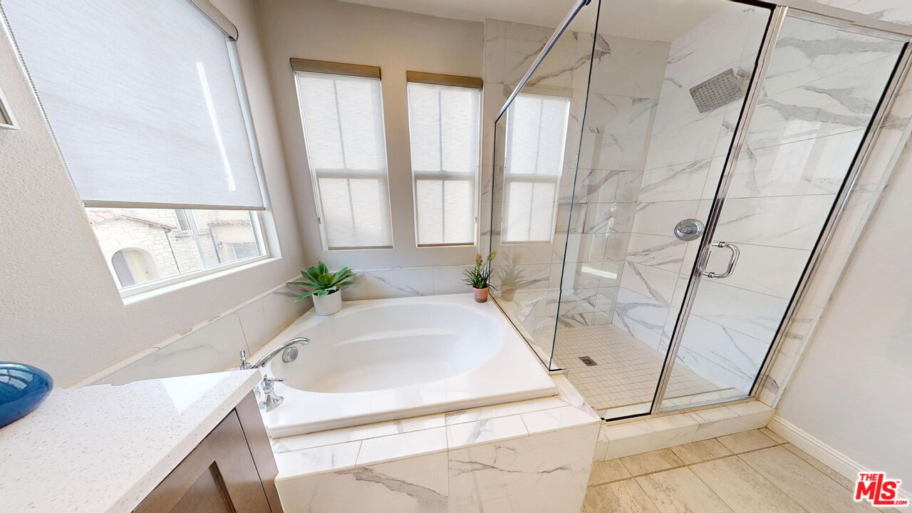 20607 West Chestnut Circle Porter Ranch, CA 91326 - Photo 21 of 52 a bath tub sitting in a bathroom next to a window
