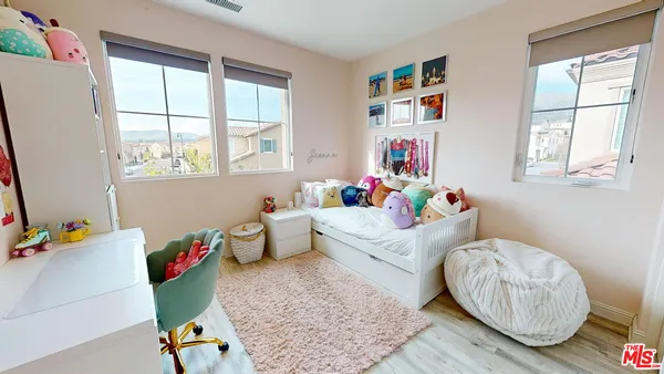 a bedroom with furniture and a wooden floor