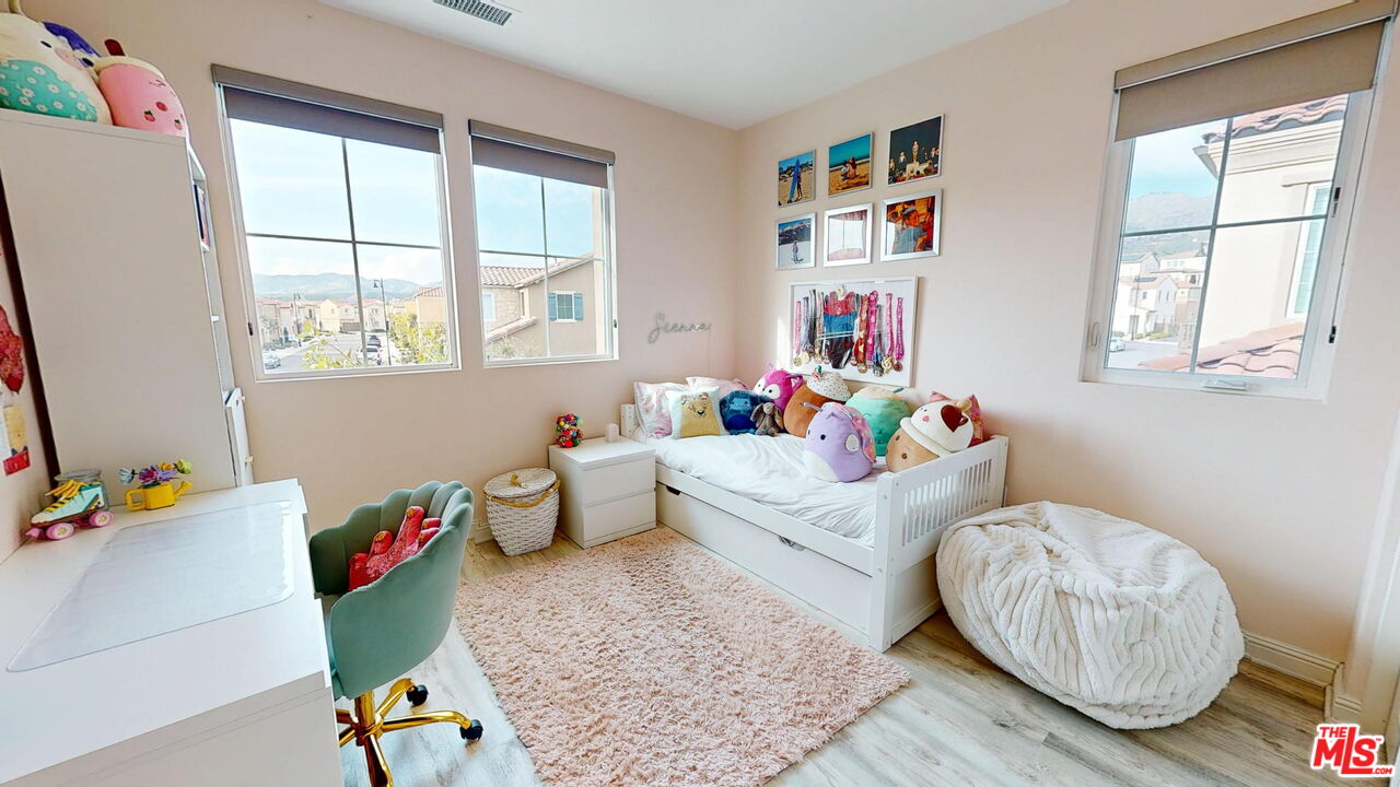 20607 West Chestnut Circle Porter Ranch, CA 91326 - Photo 23 of 52 a bedroom with furniture and a wooden floor