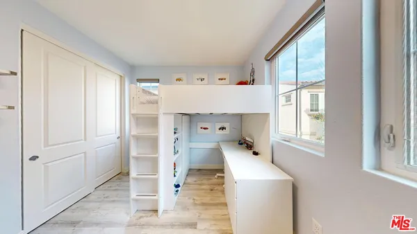 a room with a window and wooden floor