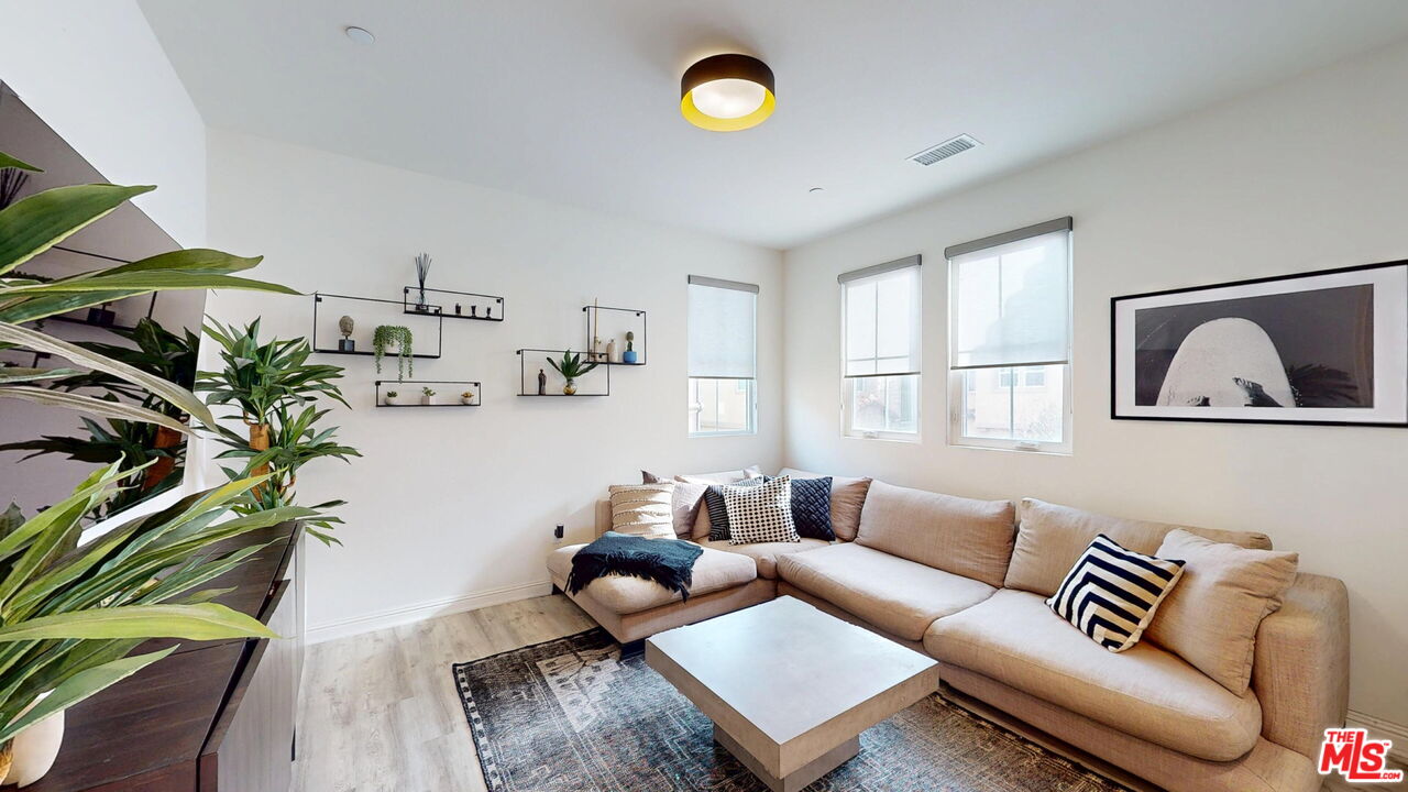 20607 West Chestnut Circle Porter Ranch, CA 91326 - Photo 28 of 52 a living room with furniture and a potted plant