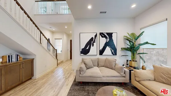 a living room with furniture and a potted plant