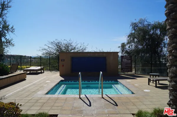 a view of house with outdoor space and swimming pool