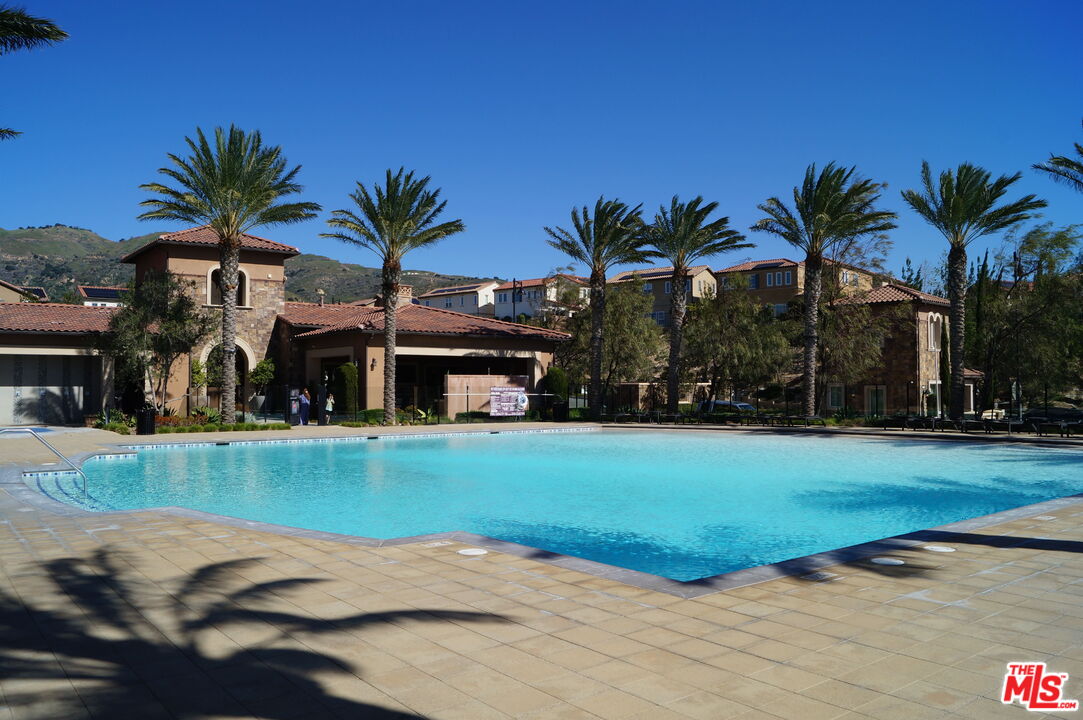 20607 West Chestnut Circle Porter Ranch, CA 91326 - Photo 40 of 52 a view of a house with a swimming pool and a yard