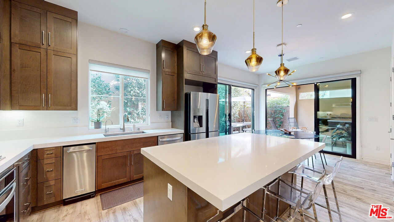 20607 West Chestnut Circle Porter Ranch, CA 91326 - Photo 6 of 52 a kitchen with a table chairs and chandelier