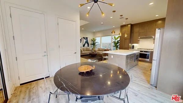 a large kitchen with a table and chairs