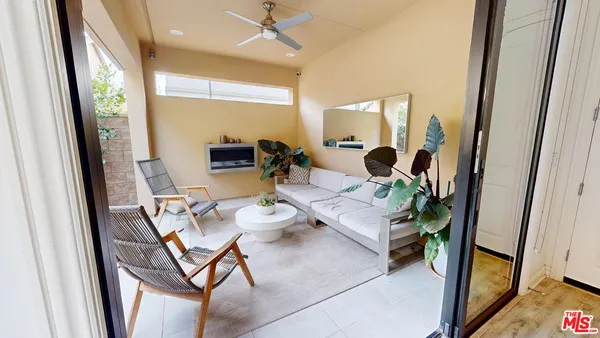 a dining room with furniture and a floor to ceiling window