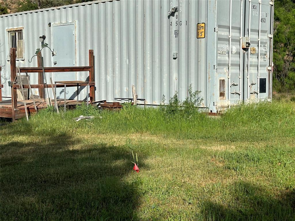 5730 Gobbler Hollow Road Brownwood, TX 76801 - Photo 18 of 37 a backyard of a house with lots of green space and plants