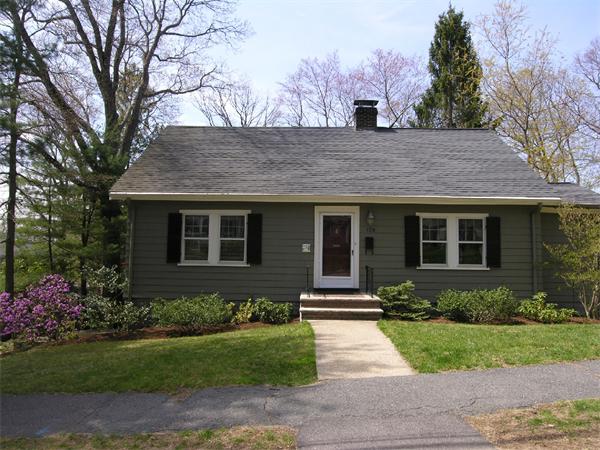 a front view of house with a garden