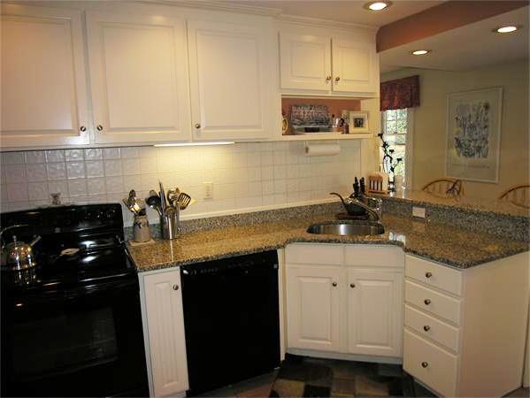 128 Hillcrest Road Needham, MA 02492 - Photo 11 of 28 a kitchen with granite countertop a sink a stove and cabinets