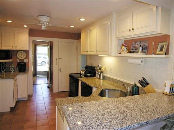 128 Hillcrest Road Needham, MA 02492 - Photo 12 of 28 a kitchen with a sink a stove and cabinets