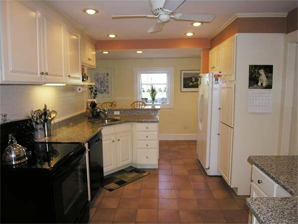 128 Hillcrest Road Needham, MA 02492 - Photo 13 of 28 a kitchen with a sink refrigerator and cabinets