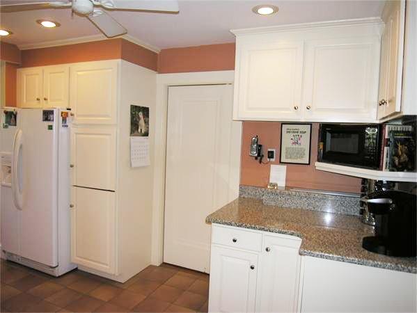 128 Hillcrest Road Needham, MA 02492 - Photo 15 of 28 a kitchen with stainless steel appliances granite countertop a refrigerator a oven and white cabinets with wooden floor