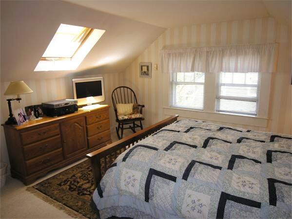 128 Hillcrest Road Needham, MA 02492 - Photo 19 of 28 a spacious bedroom with a bed a dresser a mirror and windows