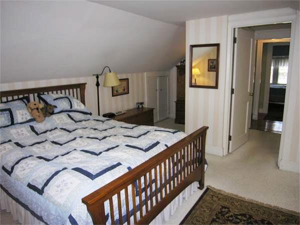 128 Hillcrest Road Needham, MA 02492 - Photo 21 of 28 a bedroom with a bed and wooden floor