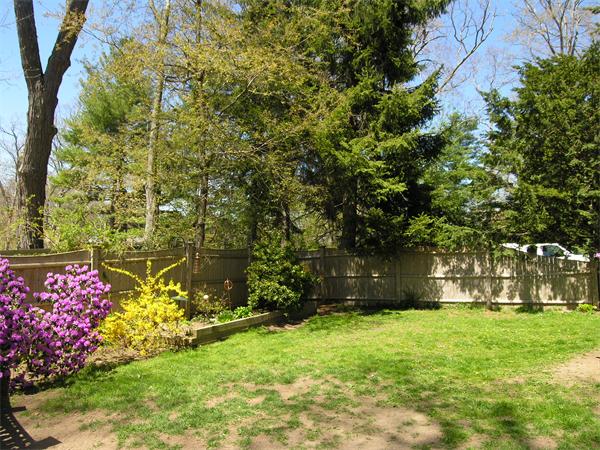 128 Hillcrest Road Needham, MA 02492 - Photo 27 of 28 a front view of a house with a yard and fountain