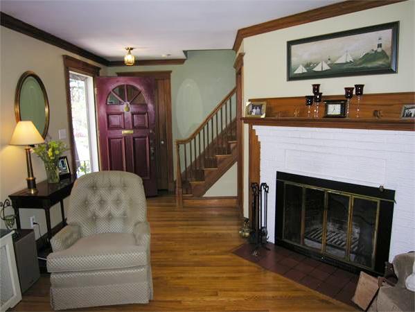 128 Hillcrest Road Needham, MA 02492 - Photo 4 of 28 a living room with furniture a flat screen tv and a fireplace