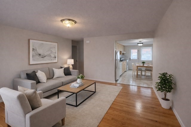 12 Cutter Street, Unit 1 Waltham, MA 02453 - Photo 2 of 9 a living room with furniture and a potted plant