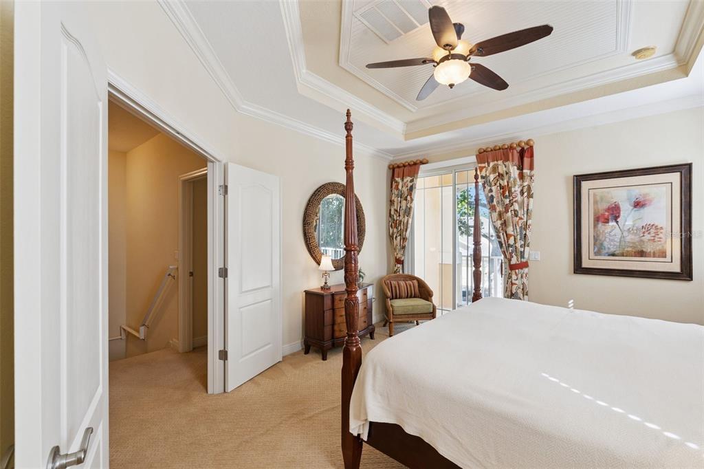 6552 Helmsley Circle Windermere, FL 34786 - Photo 16 of 53 a bedroom with a bed a chandelier and a large window