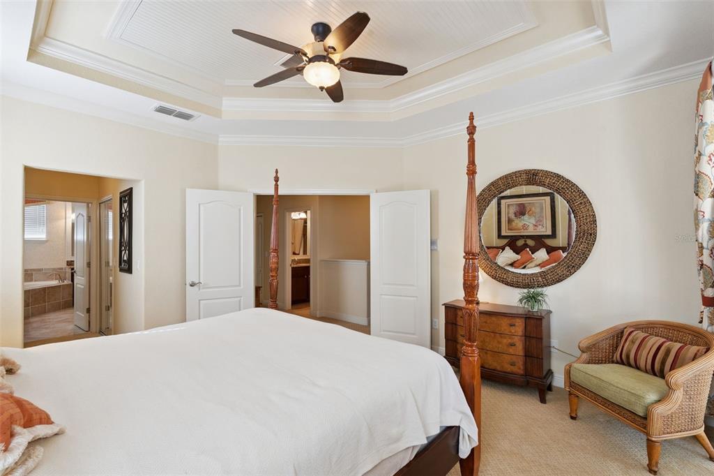 6552 Helmsley Circle Windermere, FL 34786 - Photo 19 of 53 a bedroom with a bed a couch and a chandelier