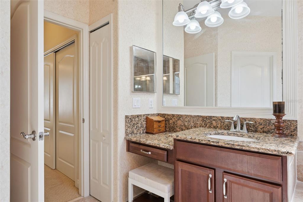 6552 Helmsley Circle Windermere, FL 34786 - Photo 23 of 53 a bathroom with a granite countertop sink a mirror and a shower