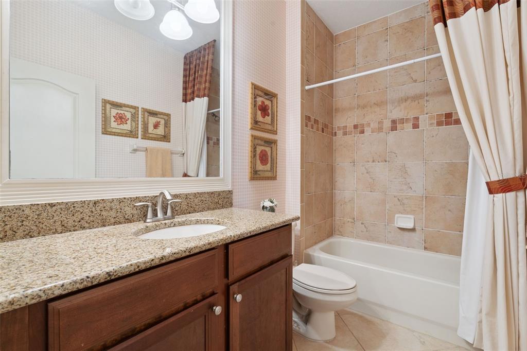 6552 Helmsley Circle Windermere, FL 34786 - Photo 29 of 53 a bathroom with a granite countertop sink toilet and shower