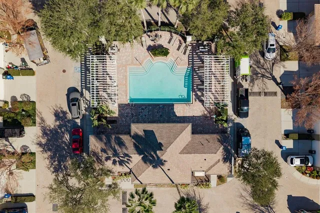 an aerial view of a house with a yard and potted plants