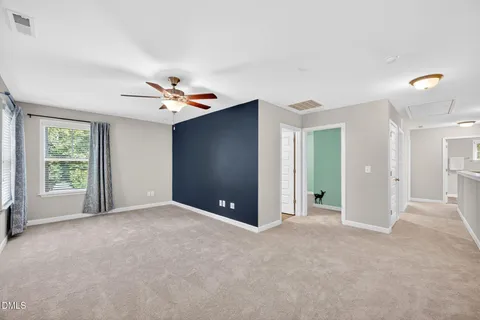 an empty room with windows and closet
